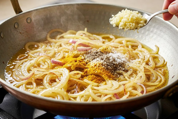 آماده‌سازی پیازداغ با سیر خردشده و ادویه‌های لازم