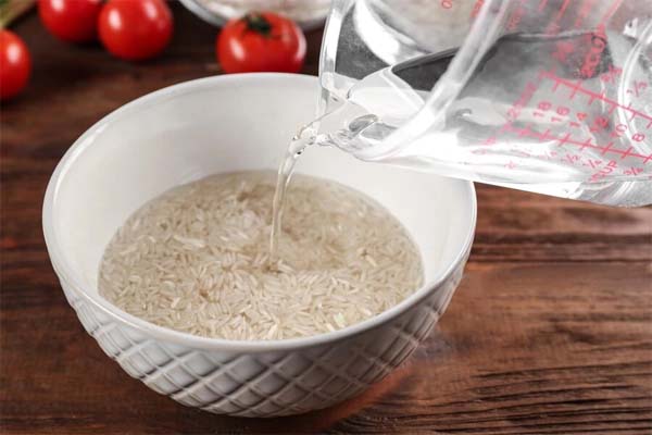 خیس کردن برنج در تهیه دمی گوجه با سیب زمینی