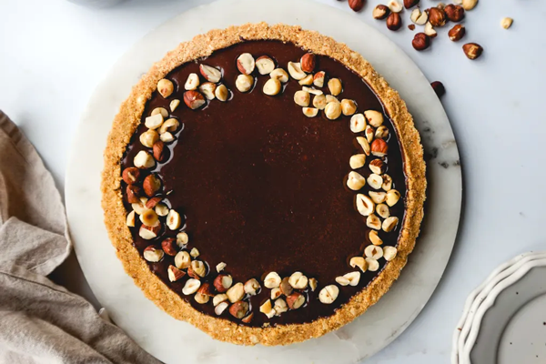 ریختن گاناش شکلات و فندق روی تارت نوتلا