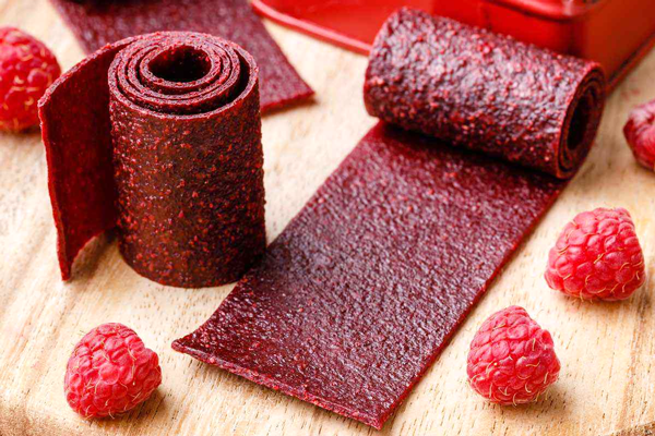 لواشک تمشک رول شده در کنار تمشک تازه