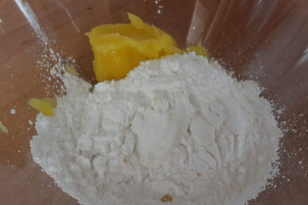 ترکیب روغن با پودر قند برای تهیه شیرینی شاه پسند
